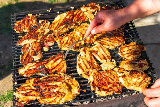 Chicken and pork steak grilled on a charcoal barbeque. Top view of camping tasty barbecue, food concept, food on grill and detail of food on the grill