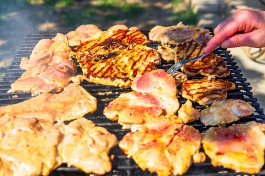 Raw steak on a charcoal barbeque. Top view of camping tasty barbecue, food concept, food on grill and detail of food on the grill