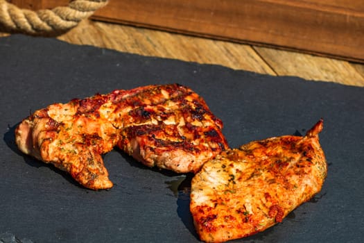 Detail of tasty pork steak on rustic background