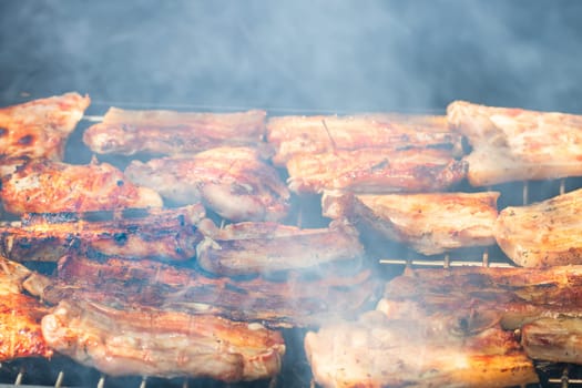 Assorted delicious tasty grilled meat with vegetables being cooked on charcoal grill