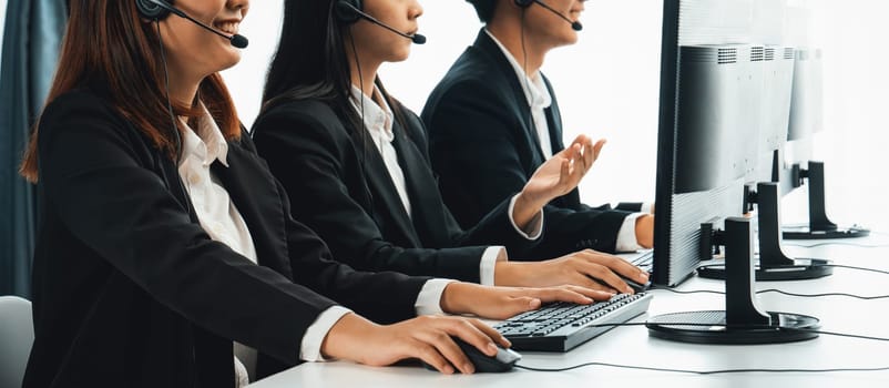 Business people wearing headset working in office to support remote customer or colleague. Call center, telemarketing, customer support agent provide service on telephone video conference oratory call