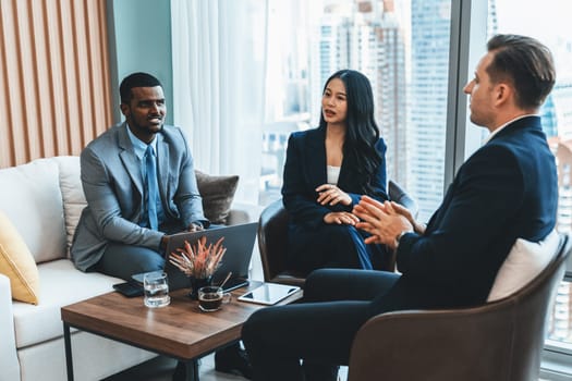 African businessman present start up project to expert investor. Group of multicultural business team solving problems, discussing business idea with skyscraper at modern business lounge. Ornamented