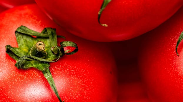 Close up of ripe red tomato, tomatoes background.