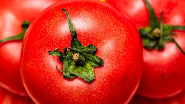 Close up of ripe red tomato, tomatoes background.