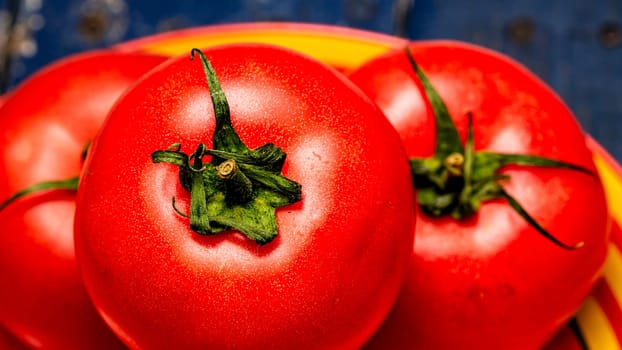 Close up of ripe red tomato, tomatoes background.