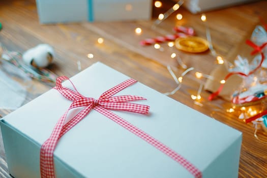Christmas composition with present box. Festive gift box inside with red ribbon.