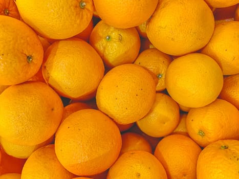Fresh mandarin oranges texture. Macro image of lots of beautiful oranges.