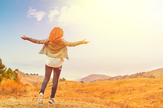 Beauty woman outdoors enjoying nature. Women enjoying nature in meadow. Outstretched arms fresh morning air summer Field at sunrise.