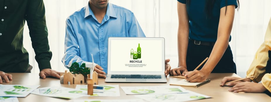 Recycle packaging displayed on laptop at a green business meeting while business team presenting green design. ESG environment social governance and Eco conservative concept. Closeup. Delineation.