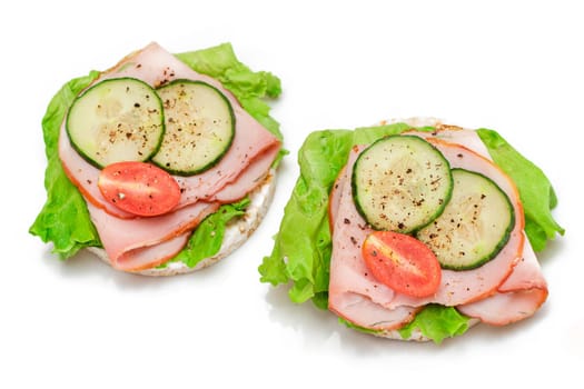 Light Breakfast. Quick and Healthy Sandwich. Rice Cake with Ham, Tomato, Fresh Cucumber and Green Salad - Isolated on White