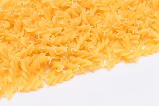 Uncooked Fusilli Pasta with Copy Space on White Background. Raw and Dry Macaroni. Fat and Unhealthy Food - Flat Lay