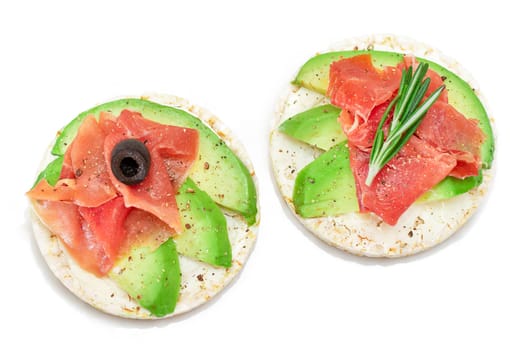 Rice Cake Sandwich with Avocado, Jamon, Olives and Rosemary - Isolated on White. Easy Breakfast. Quick and Healthy Sandwiches. Crispbread with Tasty Filling. Healthy Dietary Snack - Isolation