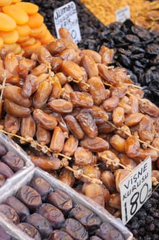 many date fruits display for sale at local market .