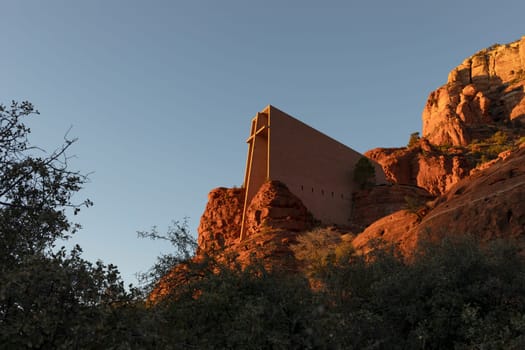 Chapel Of Holy Cross, Roman Catholic Chapel Built Into The Red Rock Buttes Of Sedona, Arizona, USA Within Coconino National Forest. Beautiful Church On Sunset, Attraction, Spiritual Place. Horizontal
