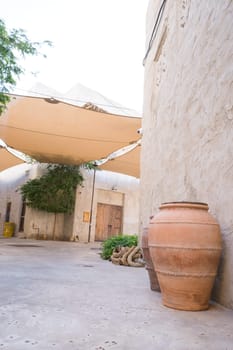 Narrow streets that create shade on a hot day in the old city of Dubai Creek and Bur district. Travel destinations and heritage village.