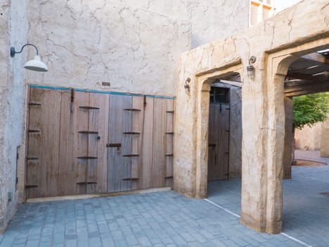 Narrow streets that create shade on a hot day in the old city of Dubai Creek and Bur district. Travel destinations and heritage village.