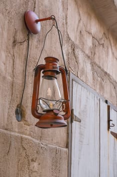 Rural view on ancient lamps and weathered walls in sunny heritage village.