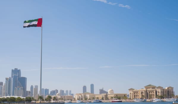 SHARJAH, UAE - February 14, 2023: Flag of the United Arab Emirates in Sharjah on the coastline