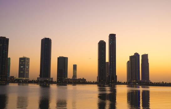 Night landscape of the embankment of the emirate of Sharjah, United Arab Emirates.