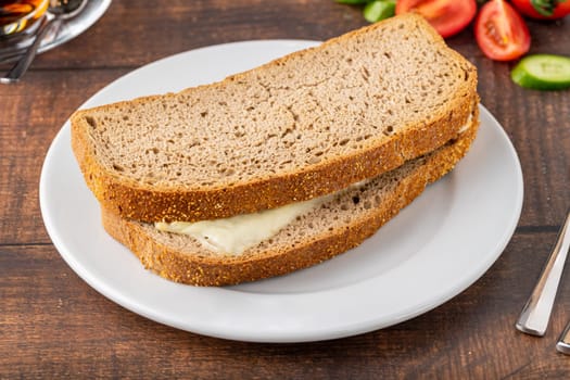 Cheddar toast on white porcelain plate on wooden table