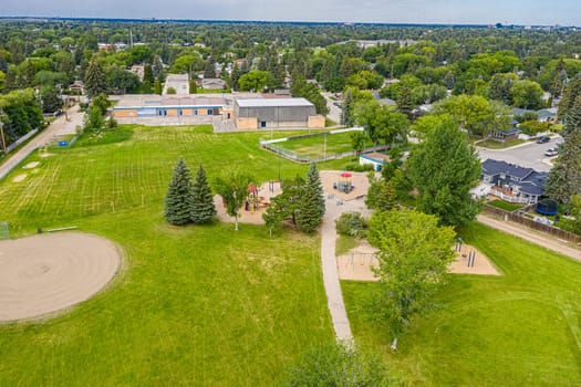 Adelaide Park in Saskatoon: a serene retreat. This image captures its lush greenery, peaceful walking paths, and the joyful play areas, making it a perfect urban escape for families and nature lovers.