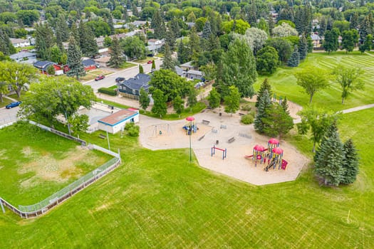 Adelaide Park in Saskatoon: a serene retreat. This image captures its lush greenery, peaceful walking paths, and the joyful play areas, making it a perfect urban escape for families and nature lovers.