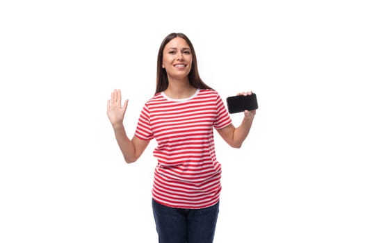 35 year old european lady in a red striped t-shirt shows the screen of a smartphone with a mockup for advertising.