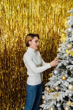 woman at christmas tree with gifts for new year