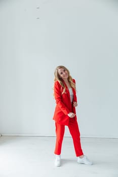 Portrait of a beautiful blonde woman in a red business suit