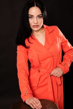 portrait of brunette woman in an orange dress