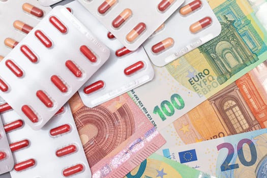 Expensive Medicine and Inflation Concept: Pills and Capsules on the Euro Banknotes. Global Pharmaceutical Industry and Big Pharma. Euro Money Bills