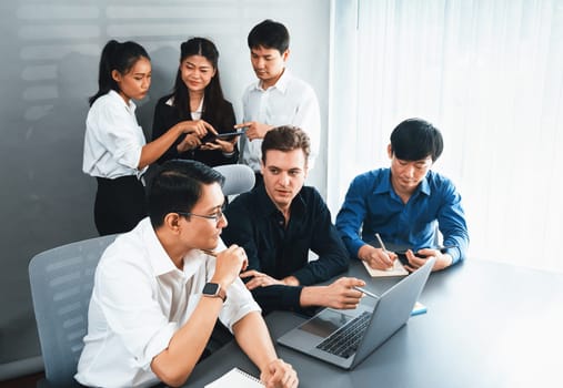 Group of diverse office worker employee working together on strategic business marketing planning in corporate office room. Positive teamwork in business workplace concept. Prudent