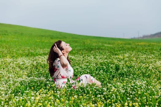 beautiful woman sitting in a green clearing in nature