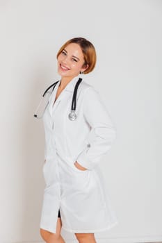 a woman doctor in white coat with phonendoscope stethoscope in hospital