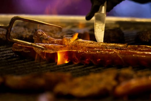 Grilling sausages on barbecue grill. Selective focus. High quality photo