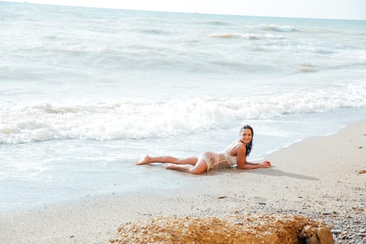 woman in light clothes lies on the beach holiday on the beach