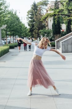 woman in a pink skirt dancing in the street