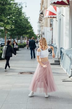 woman in a pink skirt dancing in the street