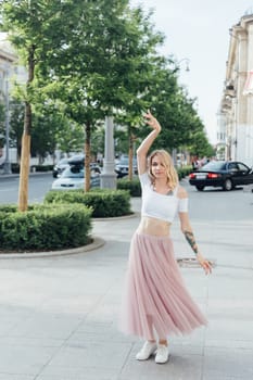 woman in a pink skirt dancing in the street