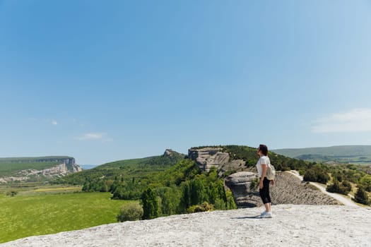 woman standing in the mountains in nature in the fresh air travel relaxing holiday