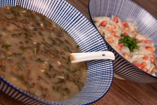 LEBANESE RECIPE FOR CHARD SOUP, LENTILS WITH LEMON, ADAS BI HAMOUD AND CHARD CHOPS, SESAME CREAM, TAHINI, POMEGRANATE SEEDS. High quality photo