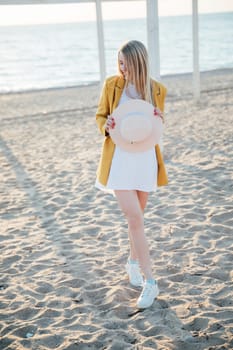 woman walks by the sea along the shore walk relaxing on the beach