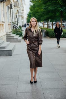 a blonde woman walks down the street walking rest pedestrian