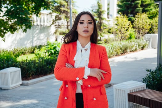 a woman in red jacket walk outside rest