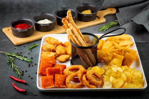 beer set with nuggets, breaded onion rings, fries and sauces