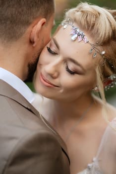 the first meeting of the bride and groom in wedding outfits in the park