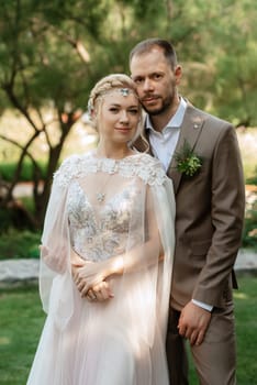 the first meeting of the bride and groom in wedding outfits in the park