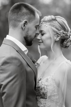 the first meeting of the bride and groom in wedding outfits in the park