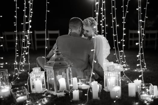 night wedding ceremony of the newlyweds in a country cottage on a green hill