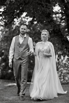 the first meeting of the bride and groom in wedding outfits in the park